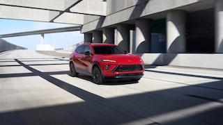 Front Three-Quarters View of the 2026 Buick Envision Compact SUV Driving Down the Freeway