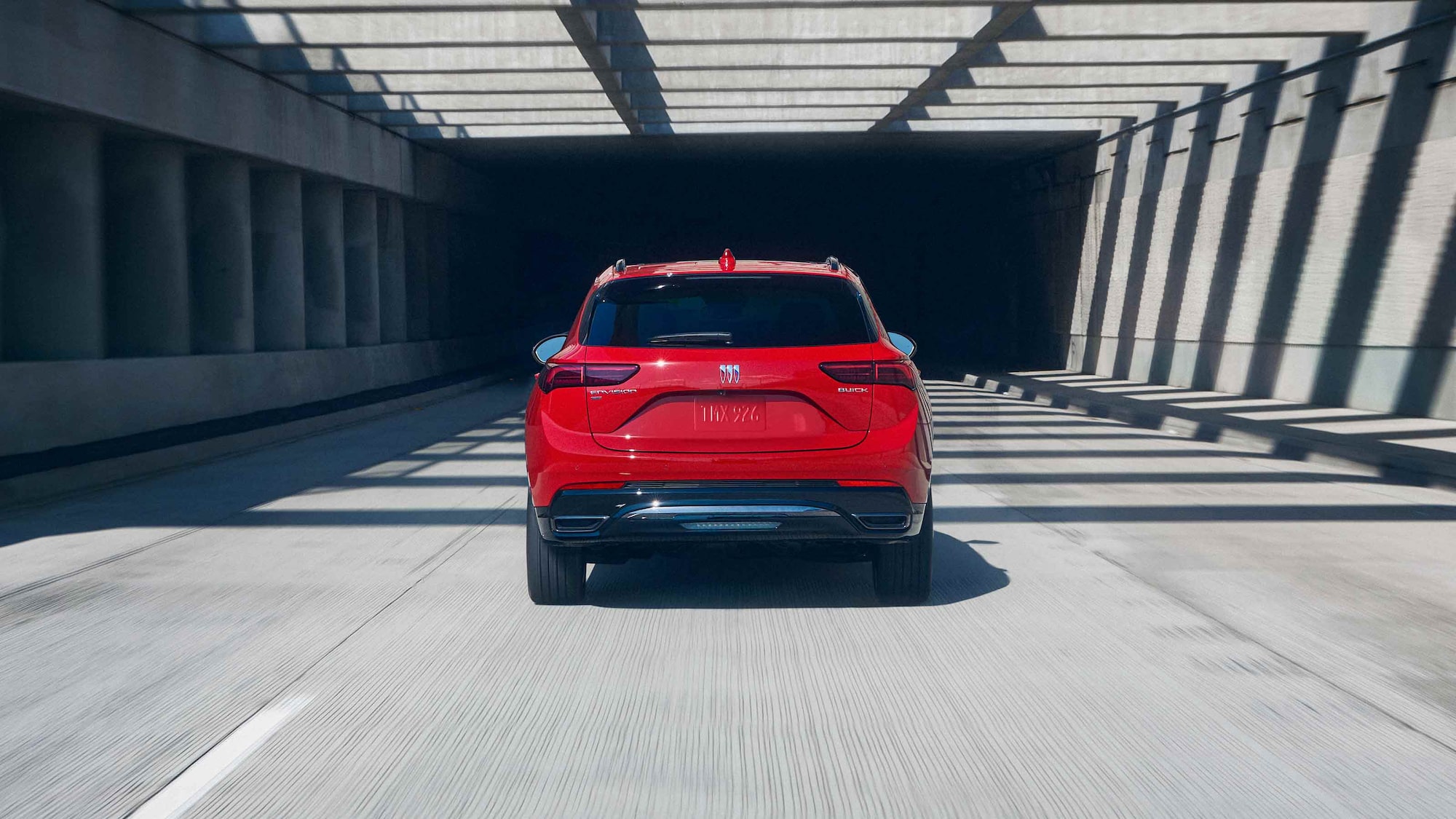 Rear View of the 2026 Buick Envision Compact SUV Driving Down a Freeway