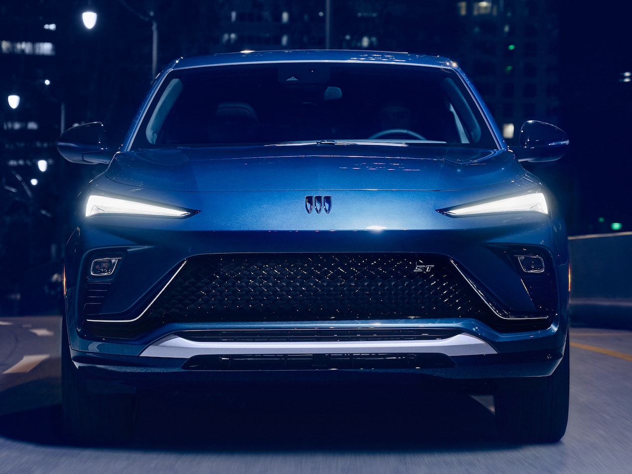 The 2026 Buick Envista Sport Touring Driving Out of the City Under a Street Light