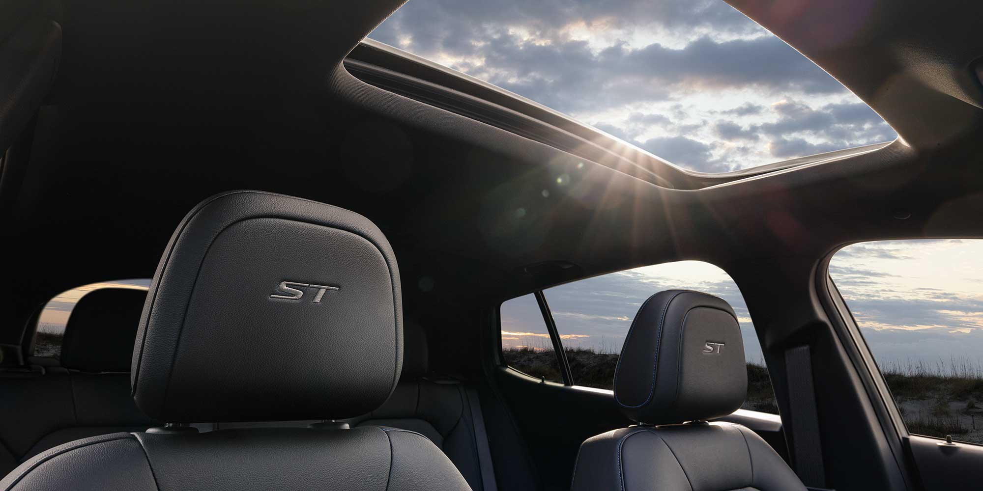 The 2026 Buick Envista Front Row Seat Head Restraints while the Sun Shines Through the Moonroof