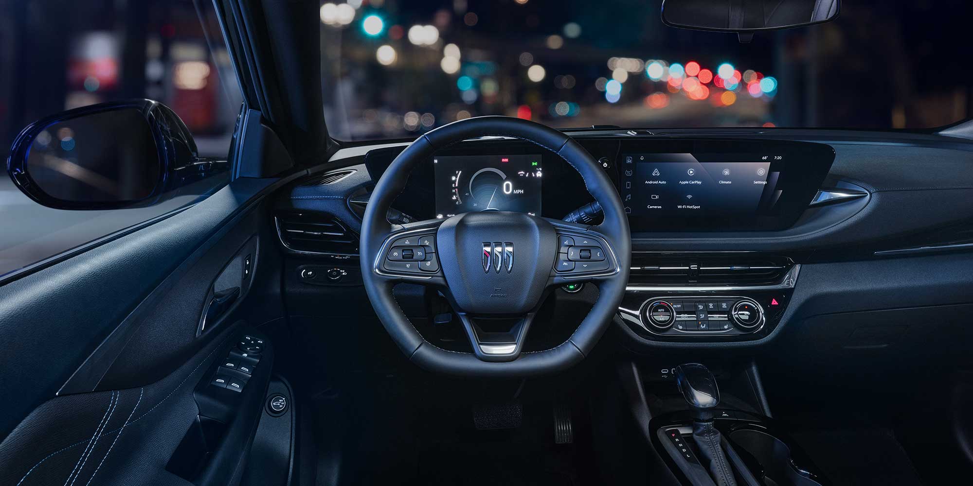 Driver Seat View of the 2026 Buick Envista Cabin and Interior Outlooking the Blurry City at Night