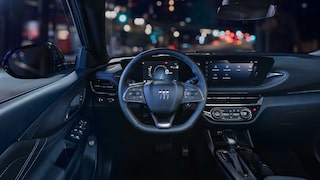Driver Seat View of the 2026 Buick Envista Cabin and Interior Outlooking the Blurry City at Night