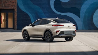 Rear View of the 2026 Buick Envista ST SUV with the Studio Series Package Parked Next to a City Building Covered with a Colorful Abstract Mural