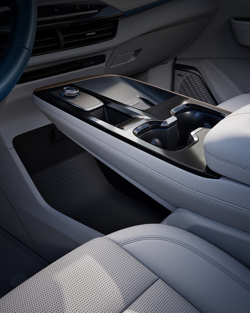 A Close-up of a Car's Center Console and Dashboard Area with a Gear Selector Dial and Cup Holders