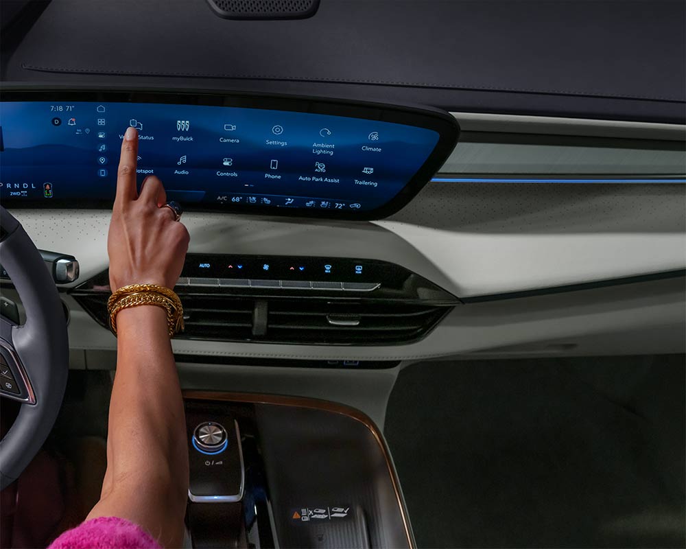 A Hand with Gold Bracelets Touching a Large Touchscreen Display in a Buick Vehicle's Interior