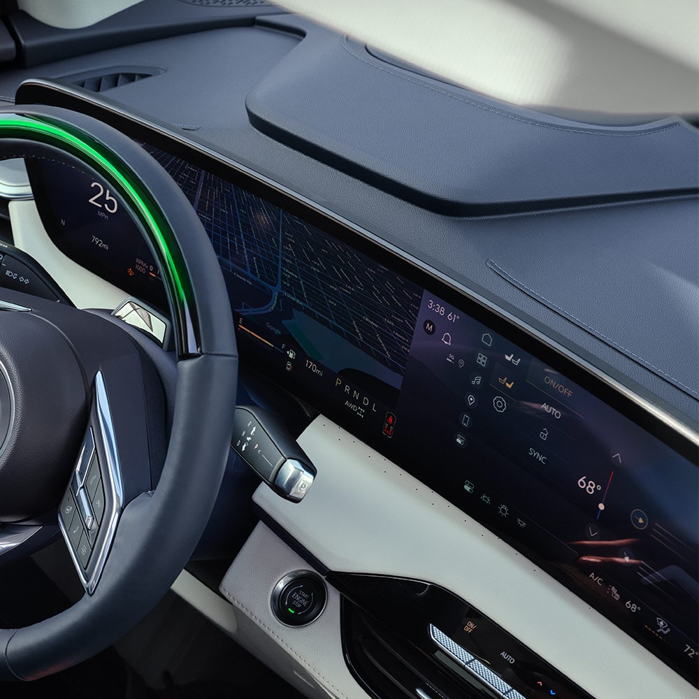 A Driver's Hand Resting on their Lap with a View of the Buick Steering Wheel and Car Door Panel