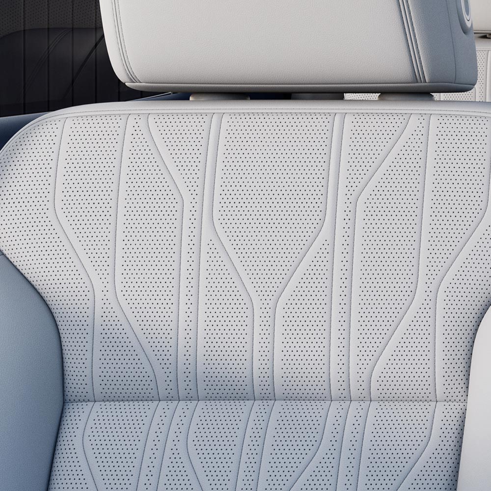 A Close-Up View of a White Perforated Leather Car Seat with Intricate Stitching