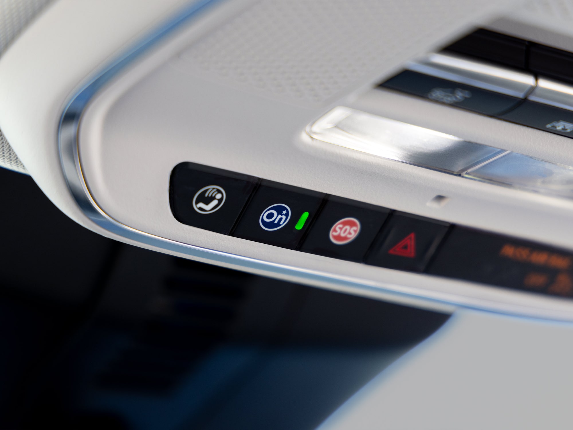 A Close-up of a Buick Car's Overhead Console with OnStar SOS and Hazard Warning Buttons