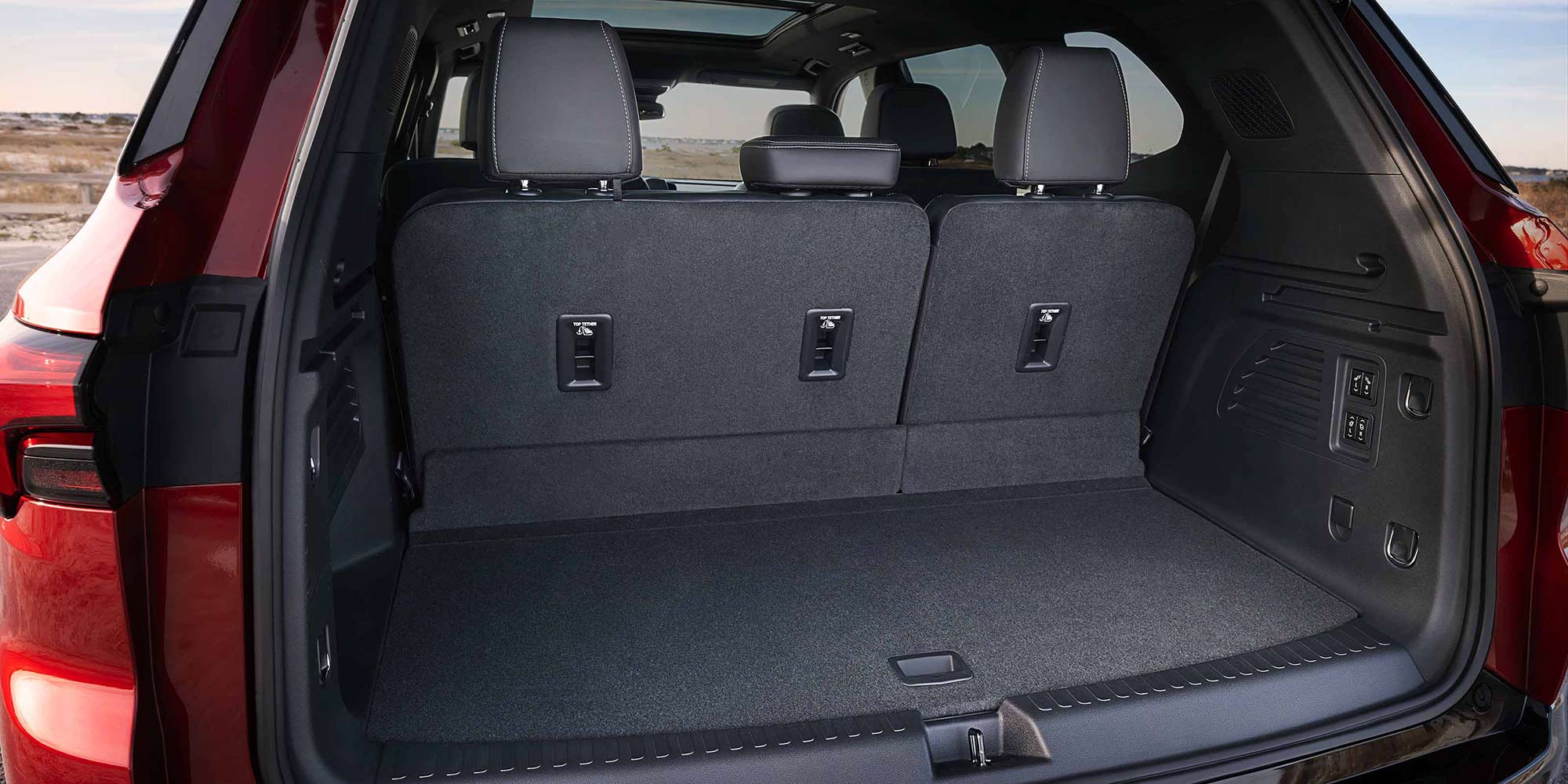 The Open Trunk of a Red Buick Enclave SUV with Gray Seats