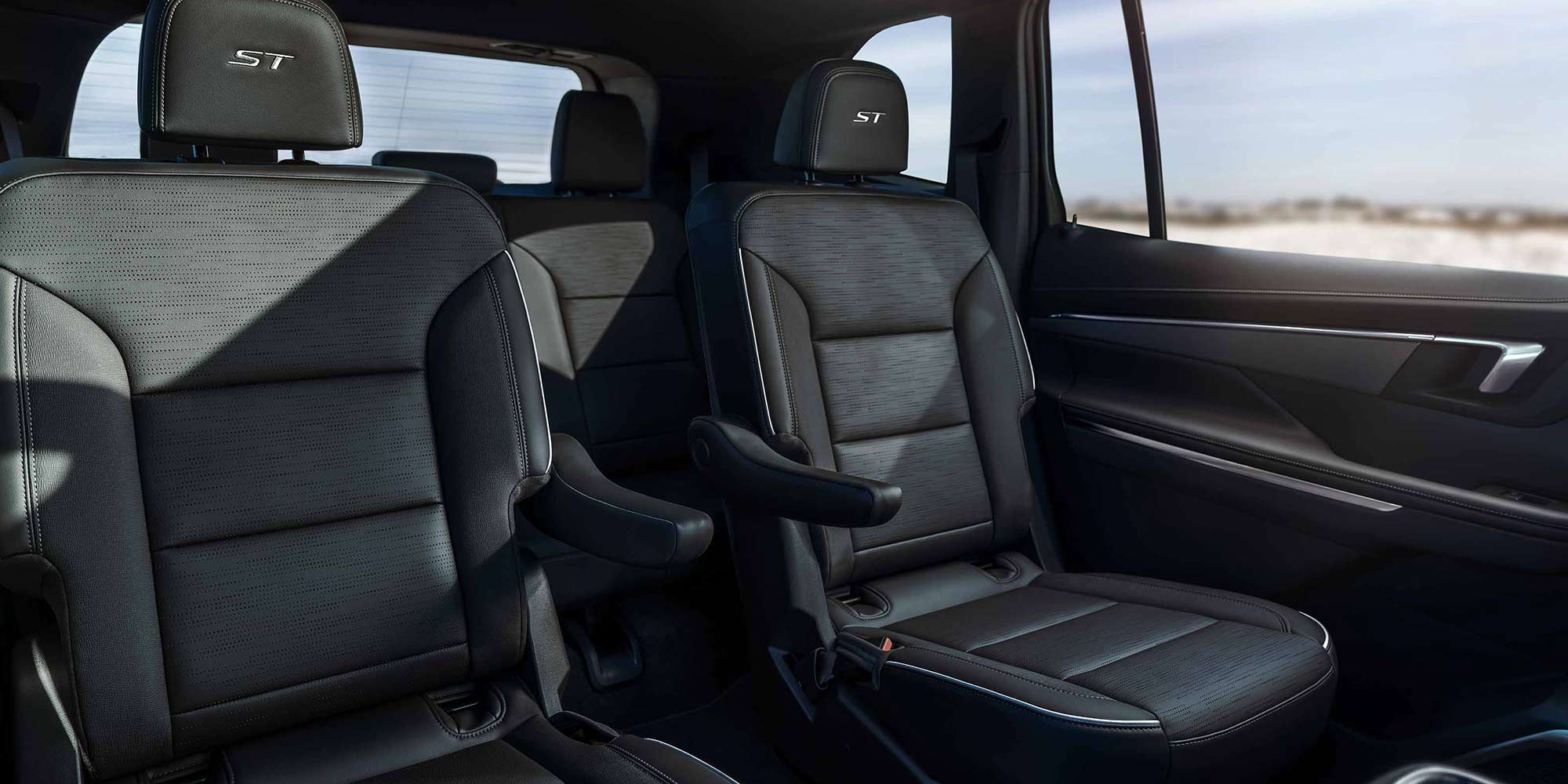 The Rear Seats of a Buick Vehicle with an Ocean View out the Window