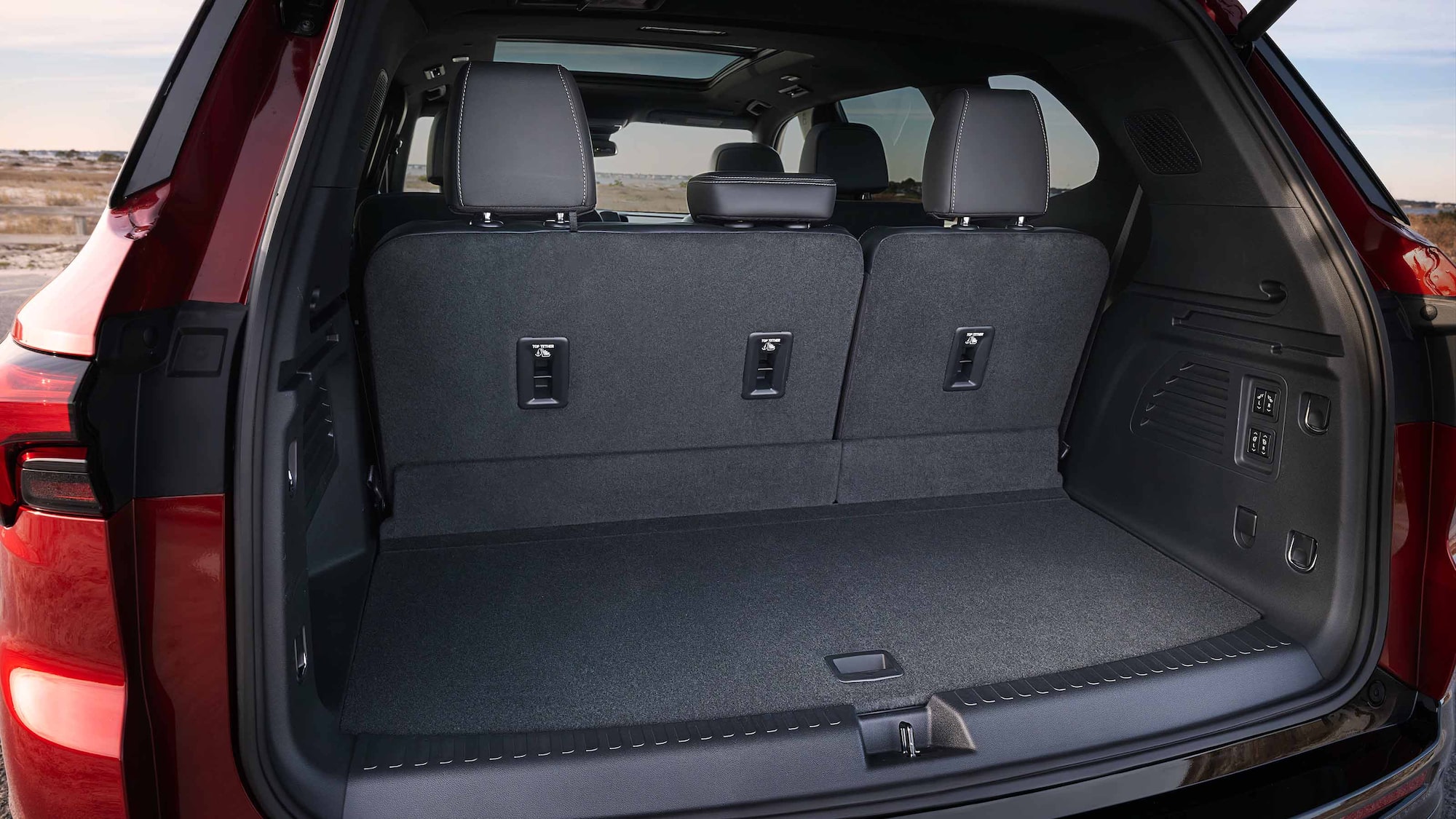 The Open Trunk of a Red Buick Enclave SUV with Gray Seats
