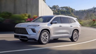 A White Buick Enclave Avenir SUV Driving on a Curved Road