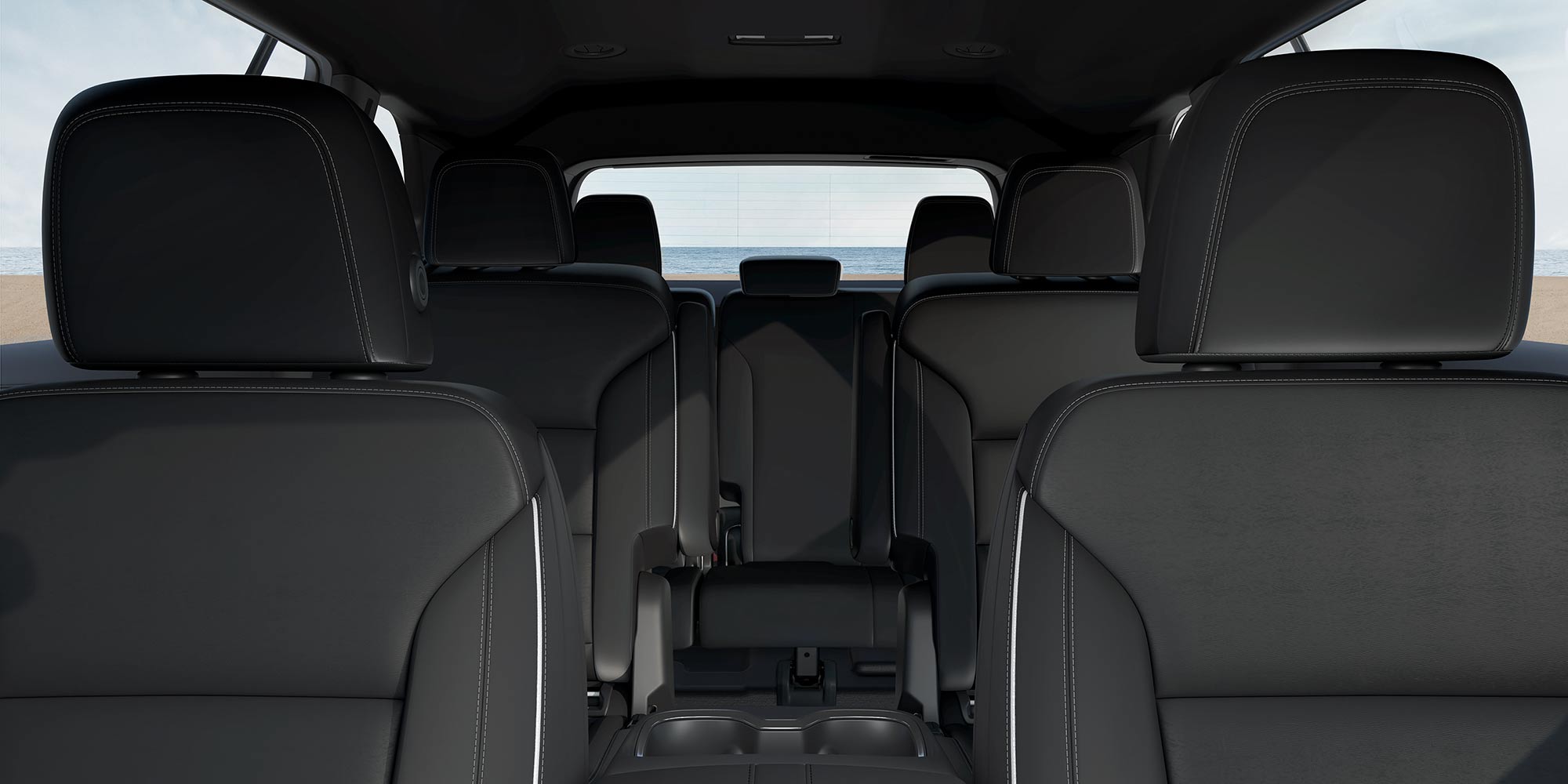 A Buick Enclave Interior with Three Rows of Black Leather Seats and a View to the Ocean