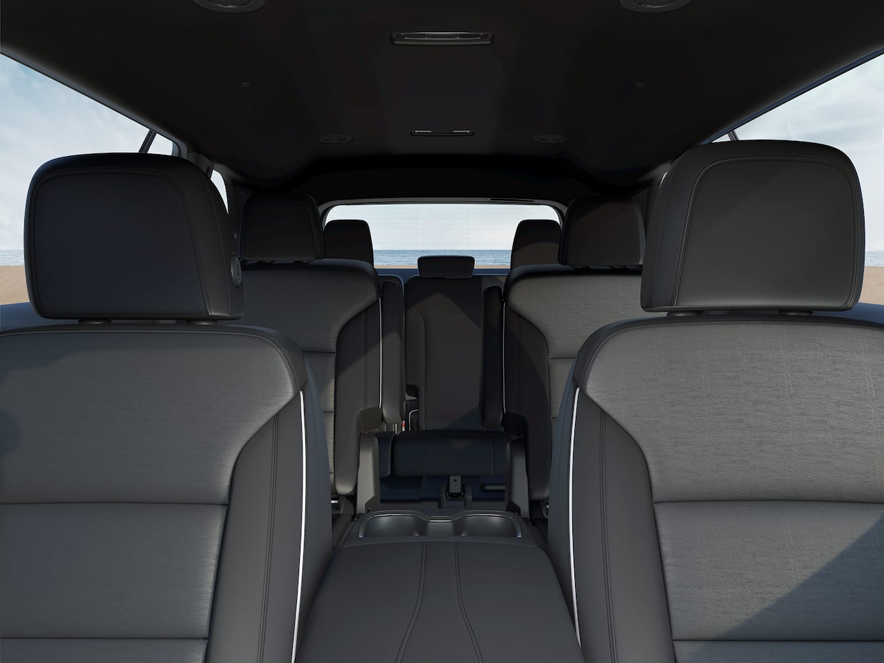 A Buick Enclave Interior with Three Rows of Black Leather Seats and a View to the Ocean