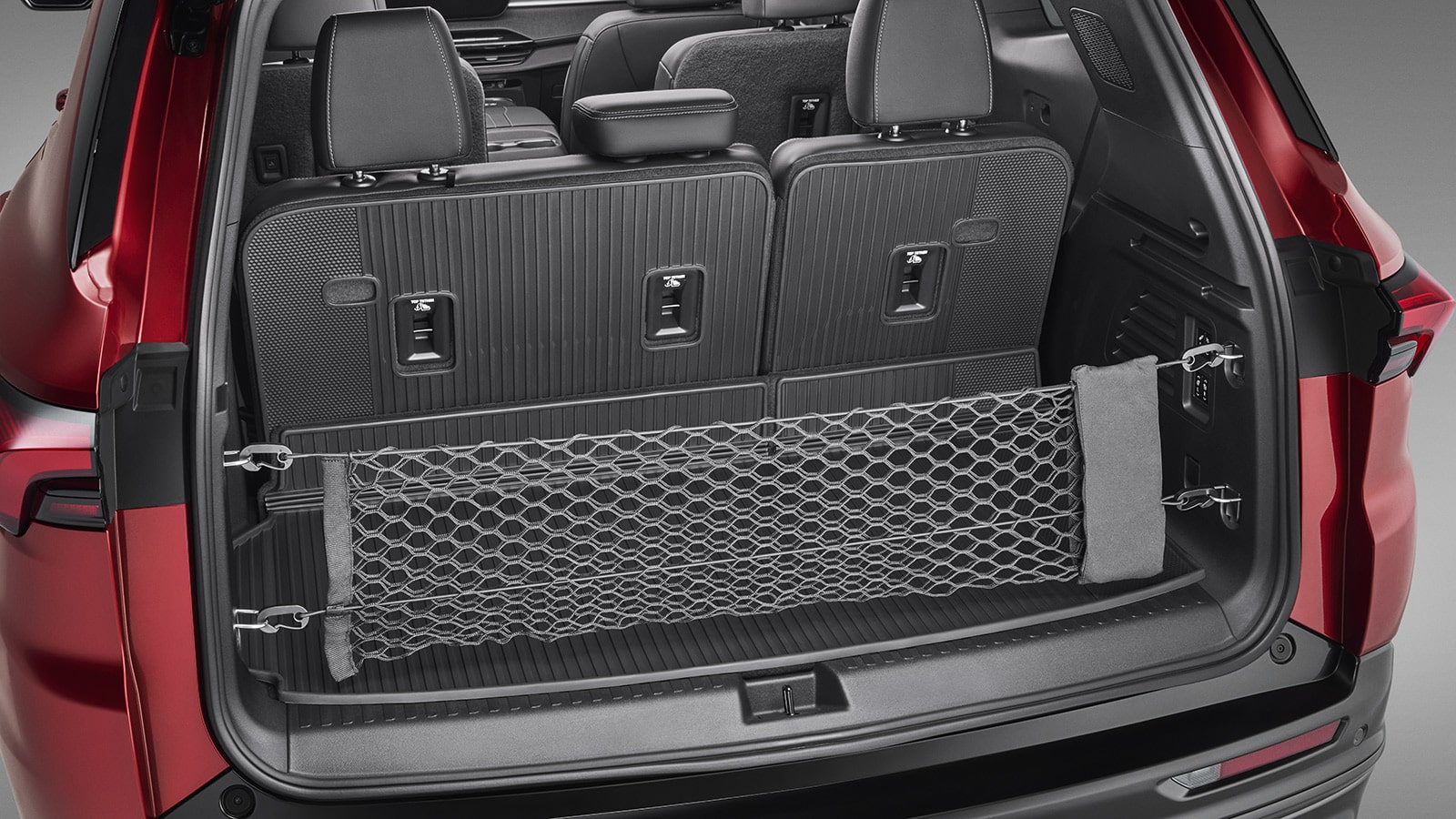 An Open Trunk of a Red Buick Enclave SUV Showing a Cargo Net