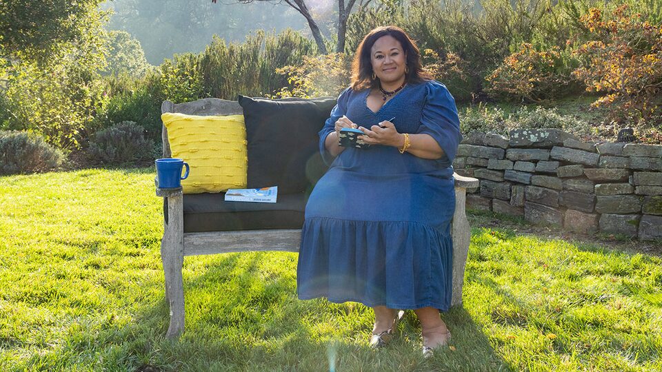 Author Jasmine Guillory Sitting on Bench Writing