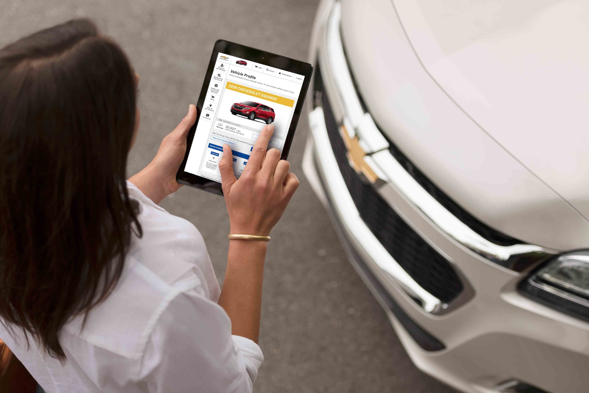 Woman holding tablet with Owner Center screen open